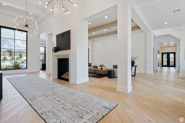 3905 S Quarry Ridge Dr, St George, UT 84790 - foyer entrance with a notable chandelier, a towering ceiling, light hardwood / wood-style floors, and a healthy amount of sunlight