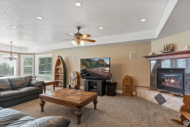 898 E 260 N, Hyde Park, UT 84318 - carpeted living room with a tray ceiling, ceiling fan with notable chandelier, a high end fireplace, and a textured ceiling
