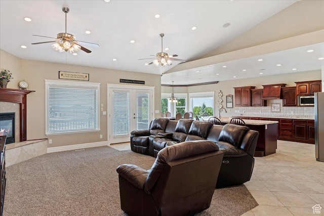 898 E 260 N, Hyde Park, UT 84318 - tiled living room featuring ceiling fan, vaulted ceiling, a fireplace, and french doors