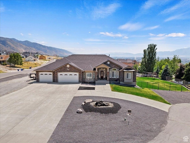898 E 260 N, Hyde Park, UT 84318 - ranch-style house with a mountain view, a garage, and a front yard