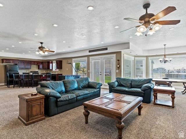 898 E 260 N, Hyde Park, UT 84318 - living room with a wealth of natural light, ceiling fan with notable chandelier, light colored carpet, and a textured ceiling