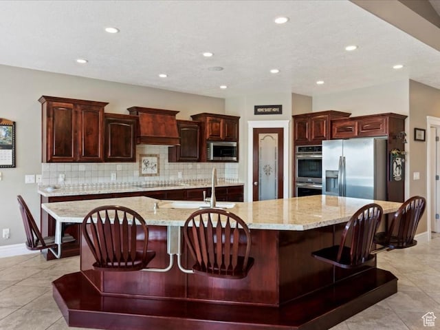 898 E 260 N, Hyde Park, UT 84318 - kitchen featuring a kitchen bar, tasteful backsplash, a spacious island, and appliances with stainless steel finishes