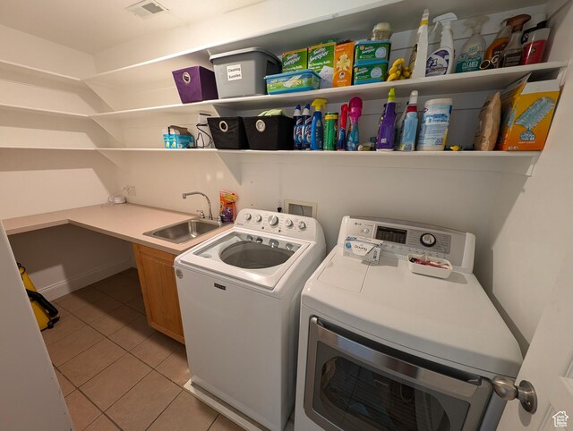 812 N Hillsdale Ln, Provo, UT 84606 - clothes washing area featuring washing machine and dryer, cabinets, light tile patterned flooring, and sink