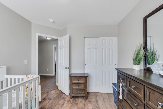 bedroom with hardwood / wood-style floors and a closet