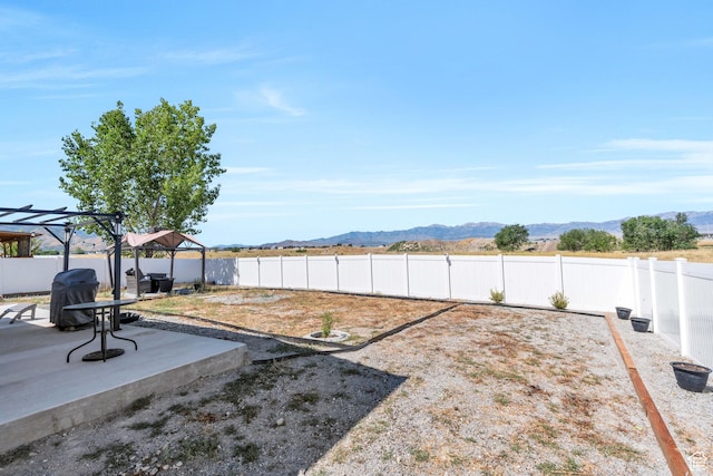 view of yard with a mountain view, a gazebo, and a patio