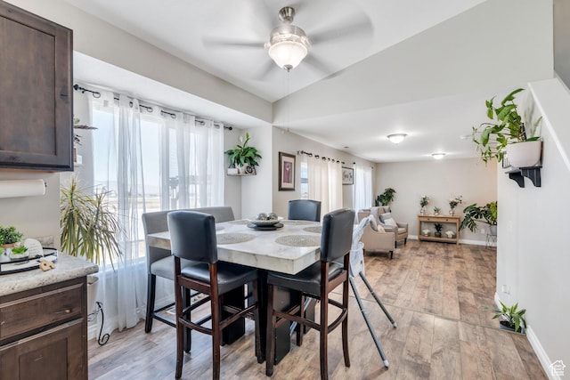 dining space featuring ceiling fan and light wood-type flooring
