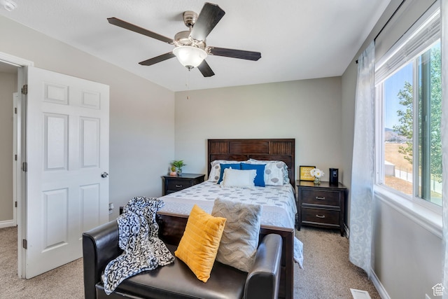 carpeted bedroom featuring ceiling fan