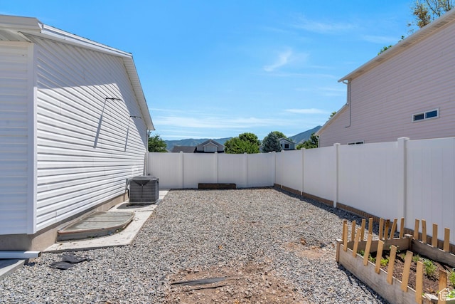 view of yard featuring a mountain view and central AC
