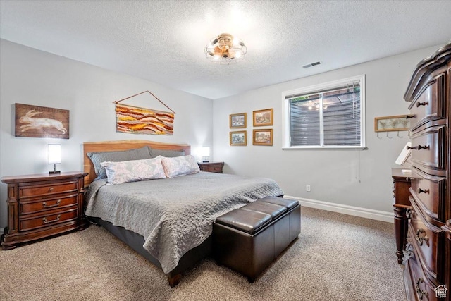 carpeted bedroom featuring visible vents, baseboards, and a textured ceiling