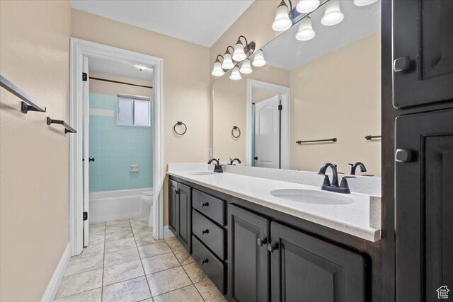 full bathroom featuring double vanity, tile patterned flooring, baseboards, and a sink
