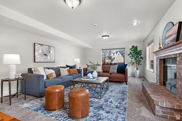 living room with a fireplace, baseboards, and carpet floors