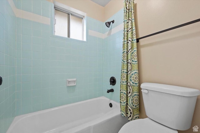 bathroom featuring toilet and shower / bath combo with shower curtain