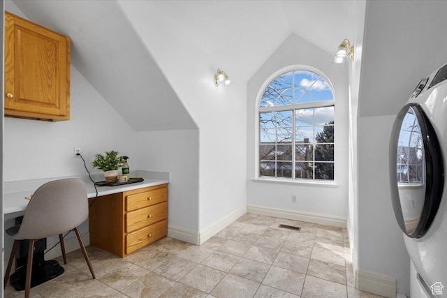 office space featuring visible vents, washer / dryer, baseboards, and lofted ceiling