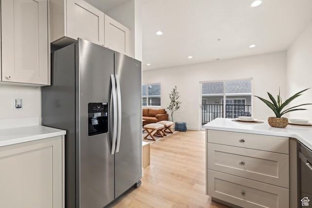 kitchen with light countertops, light wood-style flooring, stainless steel appliances, and recessed lighting