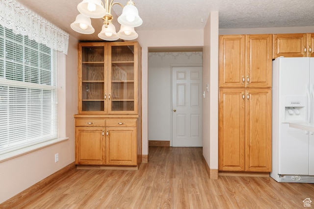 596 Eagle Dr, Preston, ID 83263 - unfurnished dining area featuring a chandelier, light hardwood / wood-style floors, and a textured ceiling
