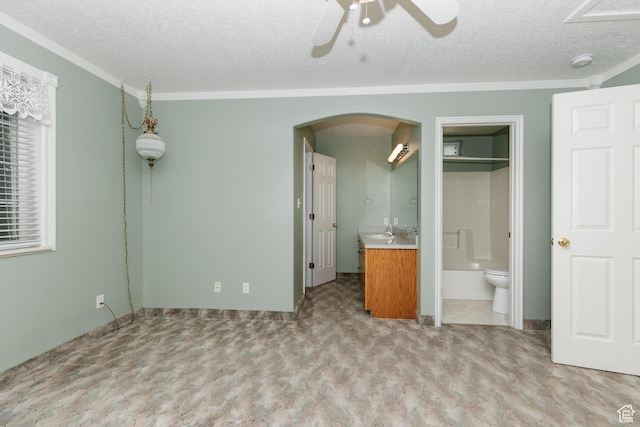 596 Eagle Dr, Preston, ID 83263 - unfurnished bedroom with crown molding, connected bathroom, light carpet, and a textured ceiling