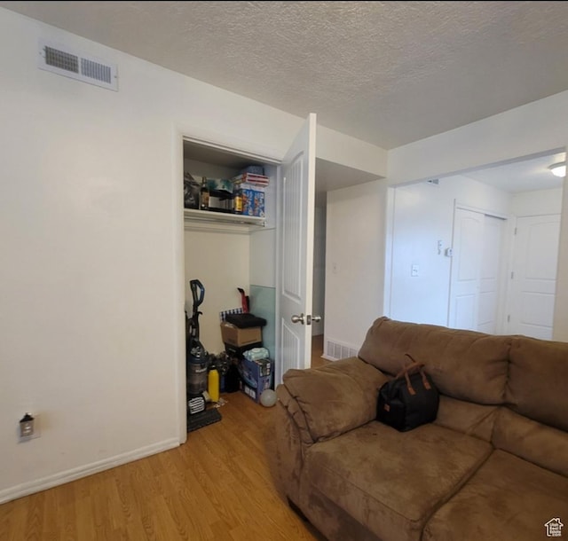246 E Helm Ave S Unit 26, South Salt Lake, UT 84115 - living area with light wood finished floors, baseboards, and a textured ceiling