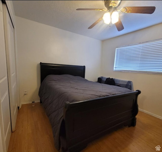246 E Helm Ave S Unit 26, South Salt Lake, UT 84115 - bedroom with light wood-type flooring, baseboards, a closet, and ceiling fan