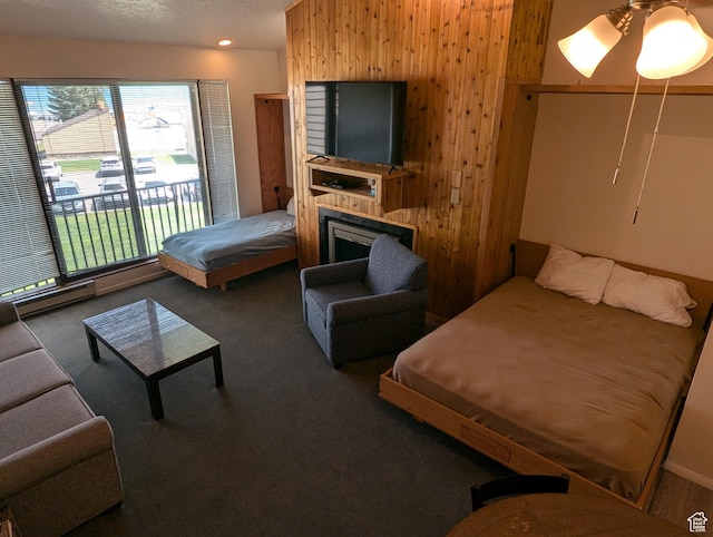 2176 S Bear Lake Blvd S Unit 452, Garden City, UT 84028 - interior space featuring a ceiling fan, access to exterior, dark colored carpet, wood walls, and a fireplace