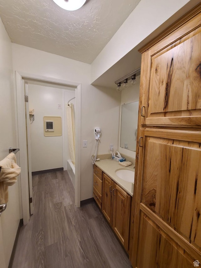 2176 S Bear Lake Blvd S Unit 452, Garden City, UT 84028 - bathroom featuring baseboards, vanity, a textured ceiling, and wood finished floors