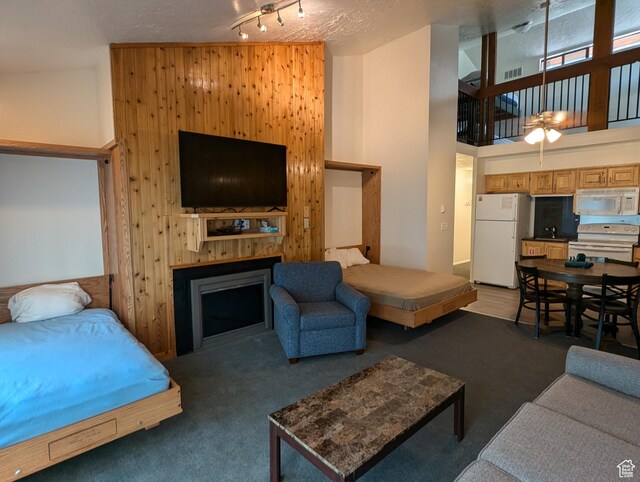 2176 S Bear Lake Blvd S Unit 452, Garden City, UT 84028 - interior space featuring a towering ceiling, a fireplace, dark colored carpet, and freestanding refrigerator