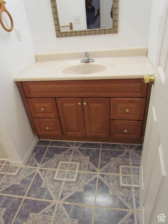 6528 S Rogers Dr, West Valley City, UT 84118 - bathroom featuring tile patterned floors and vanity