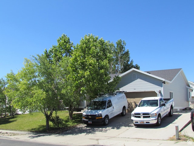 6528 S Rogers Dr, West Valley City, UT 84118 - view of front of home featuring a garage and a front lawn