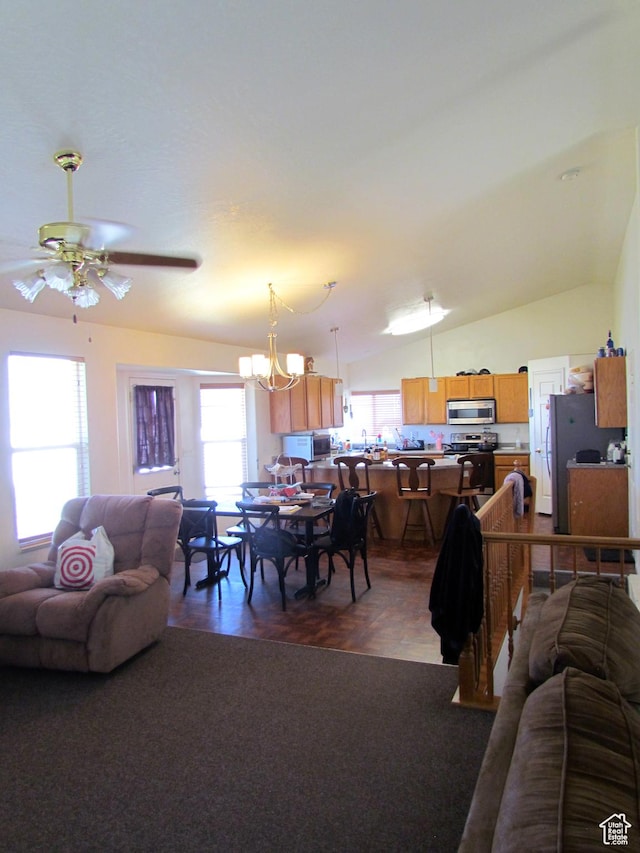 6528 S Rogers Dr, West Valley City, UT 84118 - living room with lofted ceiling and ceiling fan with notable chandelier