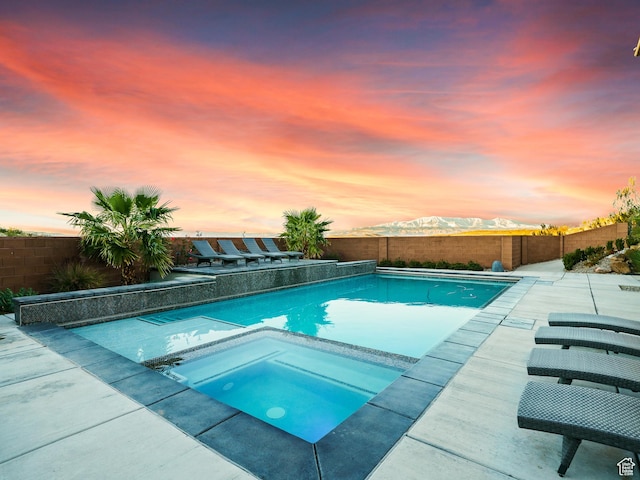 6026 S Zen Trail Way, St George, UT 84790 - pool at dusk with an in ground hot tub and a mountain view