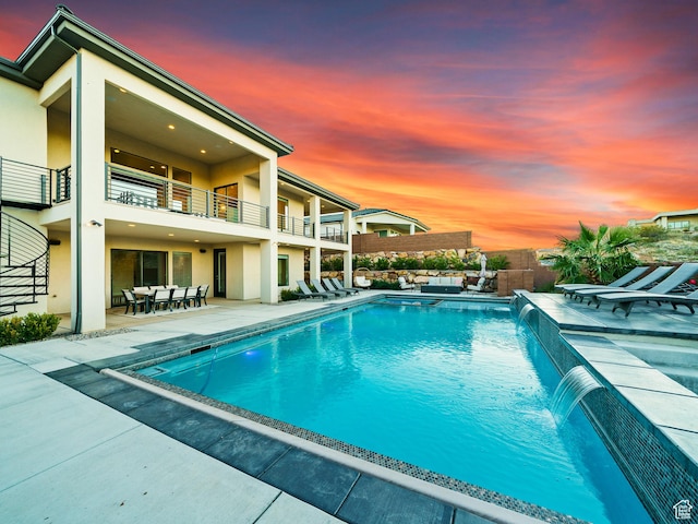 6026 S Zen Trail Way, St George, UT 84790 - pool at dusk featuring a patio and pool water feature