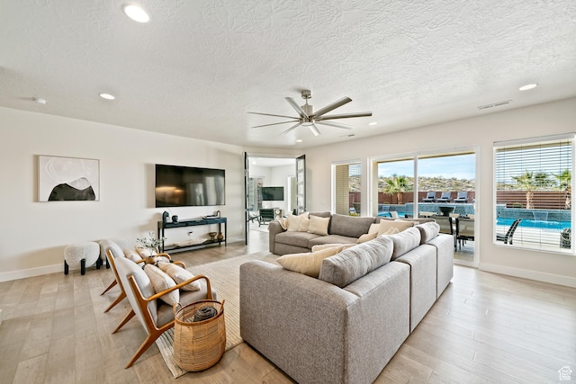 6026 S Zen Trail Way, St George, UT 84790 - living room featuring ceiling fan, a textured ceiling, and light wood-type flooring