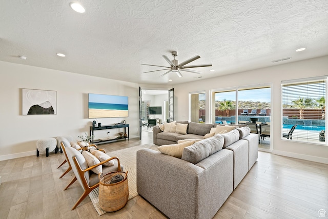 6026 S Zen Trail Way, St George, UT 84790 - living room with ceiling fan, a textured ceiling, and light wood-type flooring