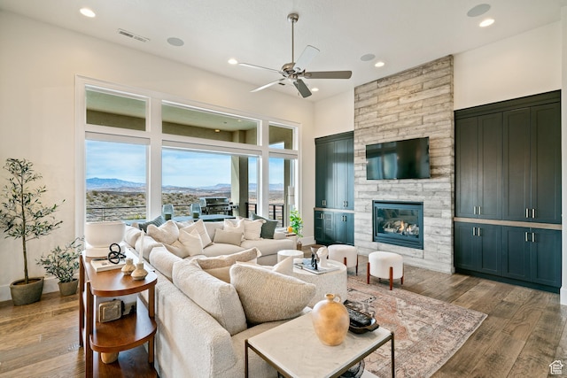 6026 S Zen Trail Way, St George, UT 84790 - living room with ceiling fan, wood-type flooring, a fireplace, and a mountain view