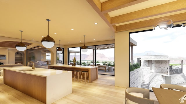 1272 N Hillside Way, Santa Clara, UT 84765 - kitchen featuring pendant lighting, sink, a kitchen island with sink, light hardwood / wood-style floors, and a mountain view