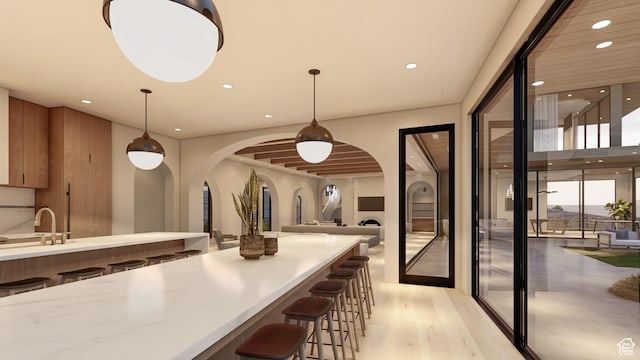 1272 N Hillside Way, Santa Clara, UT 84765 - interior space featuring a kitchen breakfast bar, sink, pendant lighting, and light hardwood / wood-style floors
