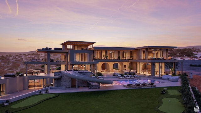 1272 N Hillside Way, Santa Clara, UT 84765 - back house at dusk with a mountain view, an outdoor living space, a patio area, and a balcony