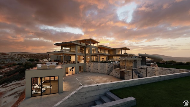 1272 N Hillside Way, Santa Clara, UT 84765 - back house at dusk featuring area for grilling, a mountain view, and a patio