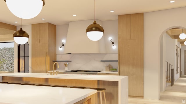 1272 N Hillside Way, Santa Clara, UT 84765 - kitchen with pendant lighting, sink, light hardwood / wood-style flooring, tasteful backsplash, and stainless steel gas stovetop