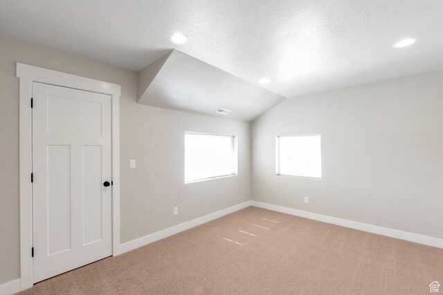 9829 N Aaron Ave Unit 213, Eagle Mountain, UT 84005 - carpeted empty room with vaulted ceiling and a textured ceiling