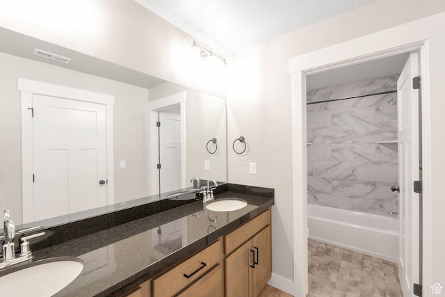 9829 N Aaron Ave Unit 213, Eagle Mountain, UT 84005 - bathroom with vanity, tiled shower / bath combo, and a textured ceiling