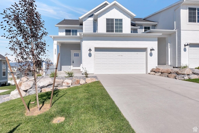 view of front of home featuring a garage and a front lawn