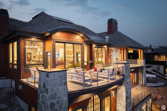 1310 Mellow Rd, Park City, UT 84060 - rear view of house featuring stone siding, a chimney, and a shingled roof