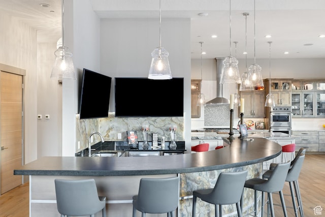 1310 Mellow Rd, Park City, UT 84060 - kitchen featuring a sink, wall chimney range hood, decorative backsplash, and stainless steel appliances
