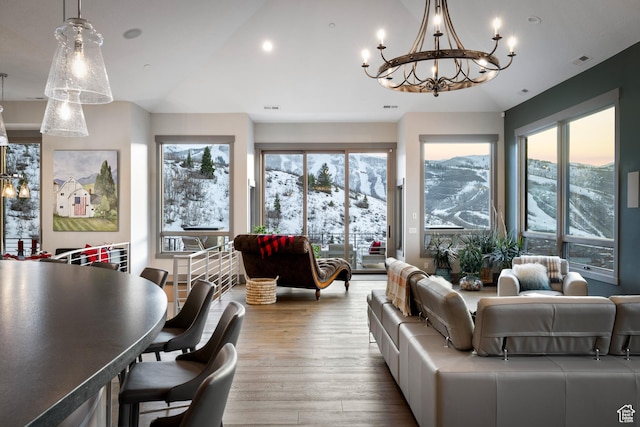 1310 Mellow Rd, Park City, UT 84060 - living room featuring a chandelier, wood finished floors, vaulted ceiling, and a wealth of natural light
