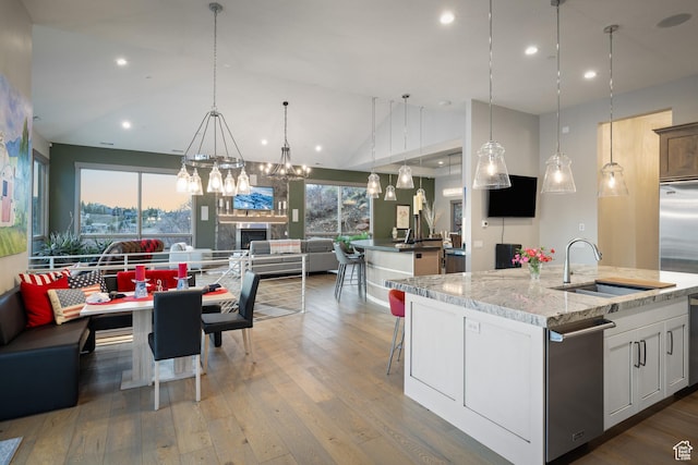 1310 Mellow Rd, Park City, UT 84060 - kitchen featuring open floor plan, wood finished floors, an island with sink, and a sink