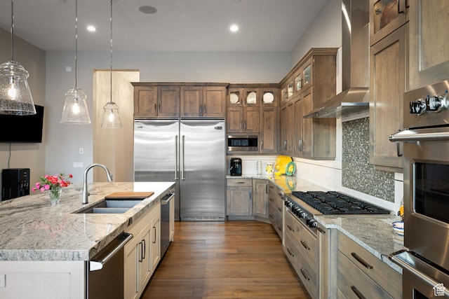 1310 Mellow Rd, Park City, UT 84060 - kitchen with light stone countertops, tasteful backsplash, wall chimney range hood, a sink, and built in appliances