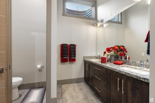 1310 Mellow Rd, Park City, UT 84060 - full bath featuring tile patterned floors, double vanity, a sink, and toilet