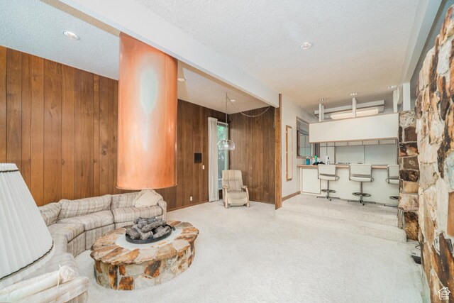 975 N 1600 E, Logan, UT 84321 - living area with wood walls, carpet, and a textured ceiling