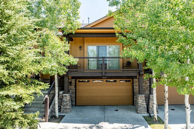 14160 N Council Fire Trl, Heber City, UT 84032 - view of front of property featuring concrete driveway, a garage, a balcony, and stone siding