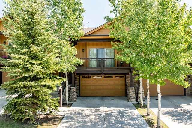 14160 N Council Fire Trl, Heber City, UT 84032 - view of front of house with driveway, an attached garage, and stone siding